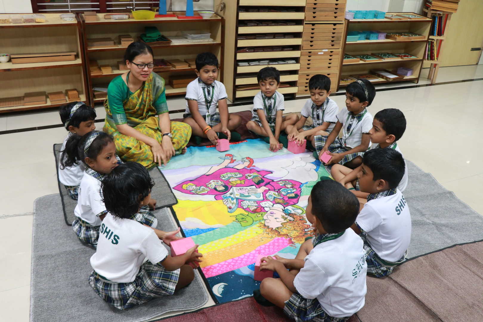 A teacher guiding a child through a Montessori activity